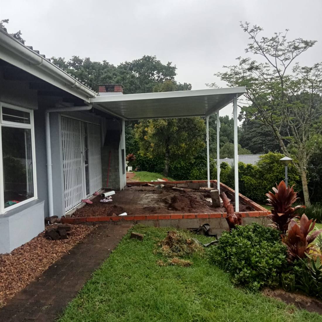 Carport roof structure installed onto house